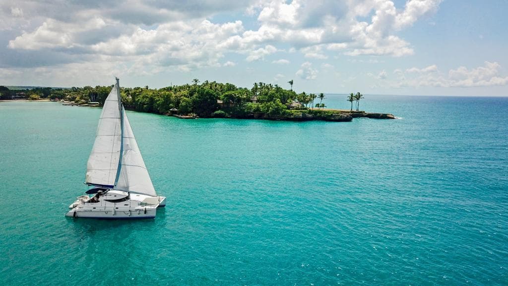 Catamaran sailing through turquoise Punta Cana water