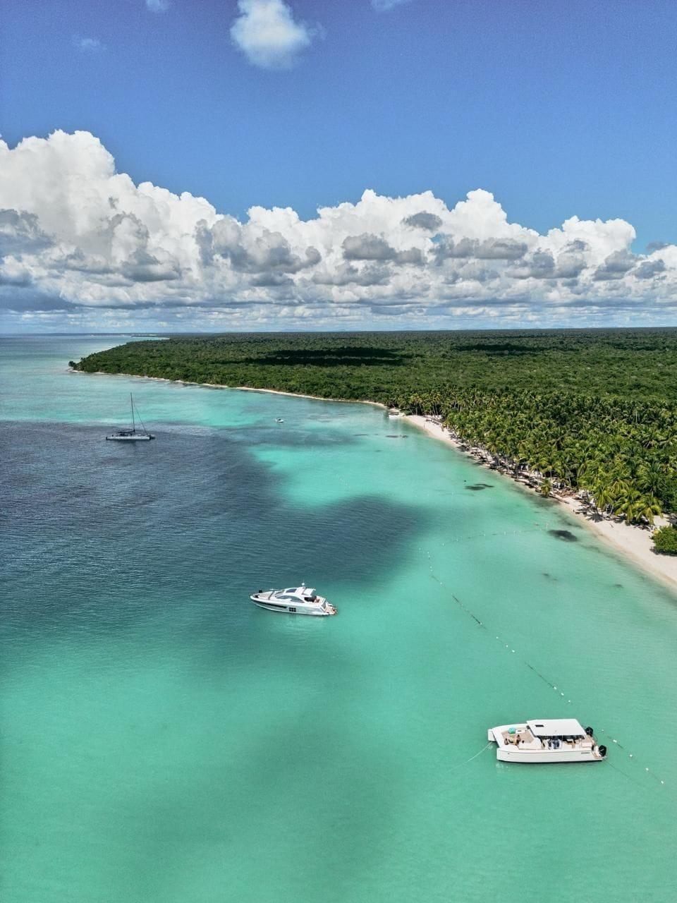 Aerial Saona Island coastline with turquoise water and tour boats